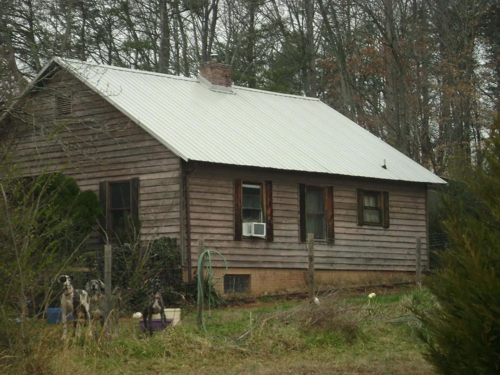White metal roof on an old wood sided farmhouse, from a Metal Roof Installation job in Maury